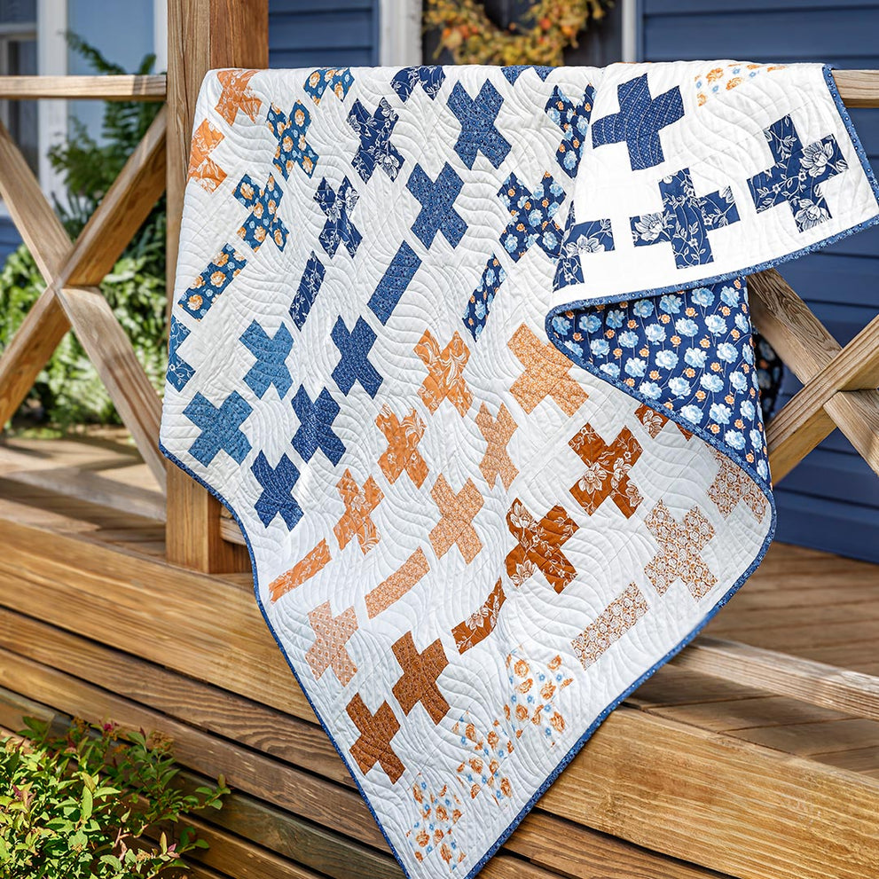 a modern jelly roll quilt pattern featuring the popular plus quilt block.