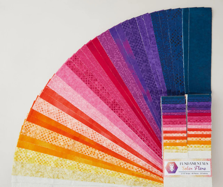 curated fabric streps arranged in an ombre display from the fundamentals fabric collection by white owl textiles.