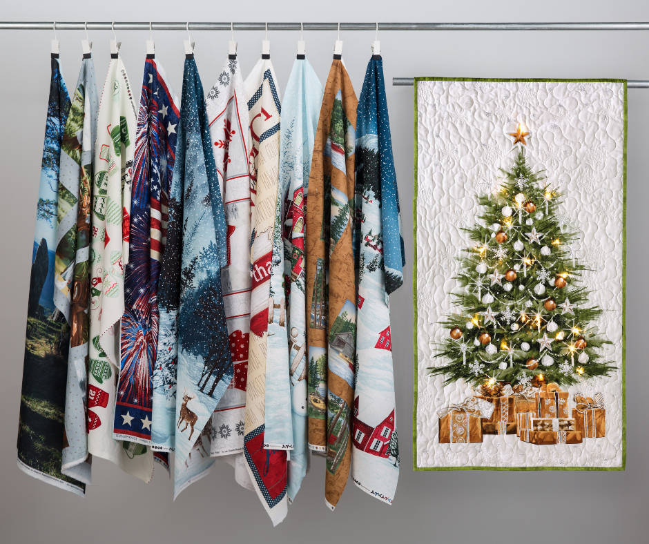 A row of colorful fabric panels with various festive designs hangs beside a quilted panel featuring a Christmas tree adorned with lights and gifts, creating a cozy, cheerful holiday ambiance.