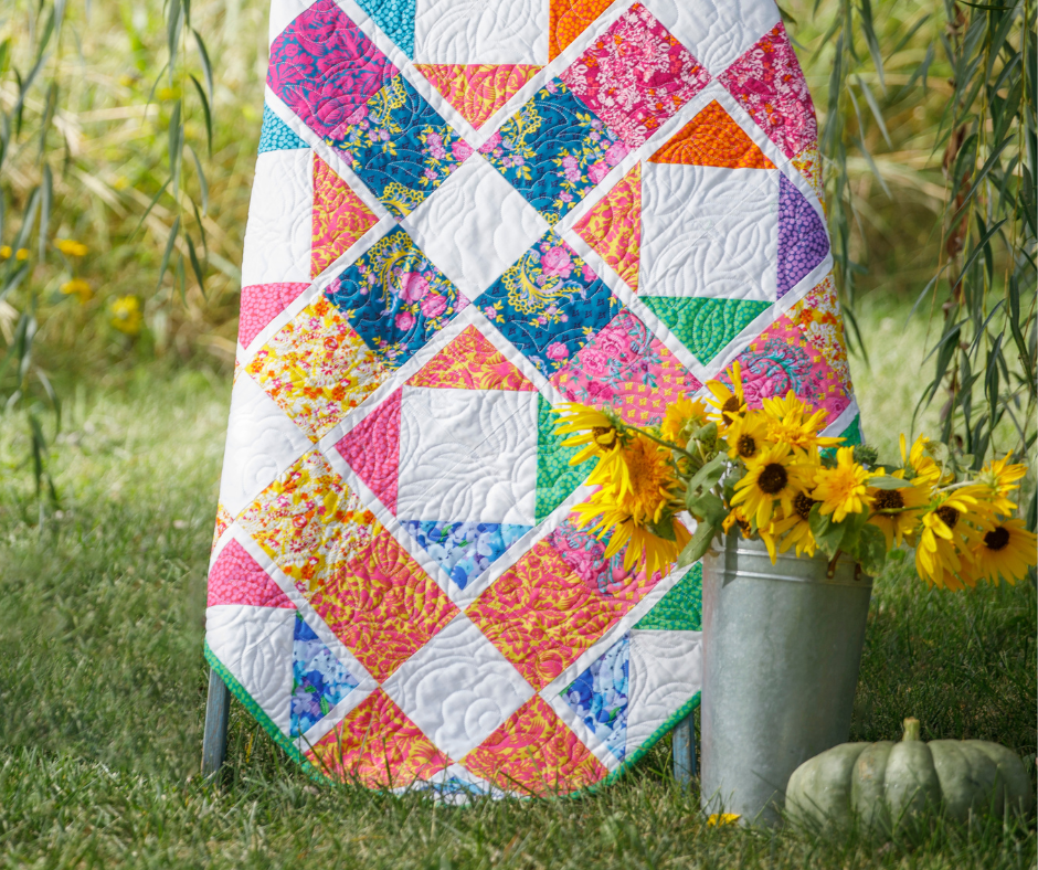 a colorful quilt made with floral fabrics.