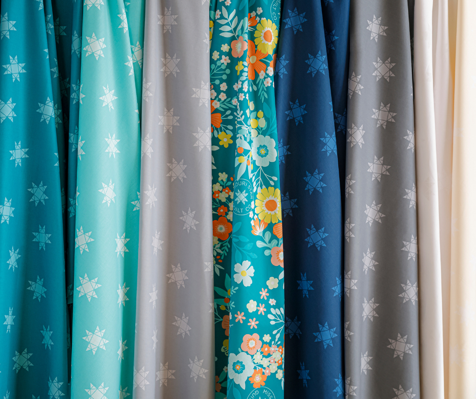 a selection of extra wide quilt backings in a variety of blues, greys, and neutrals.