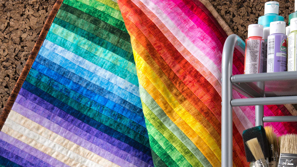 Colorful jelly roll strips for an easy beginner quilt tutorial.