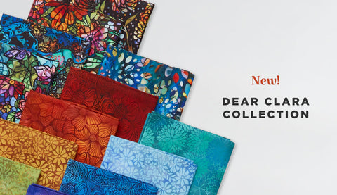Fat quarter bundle of cotton quilting fabric with the look of colorful stained glass.