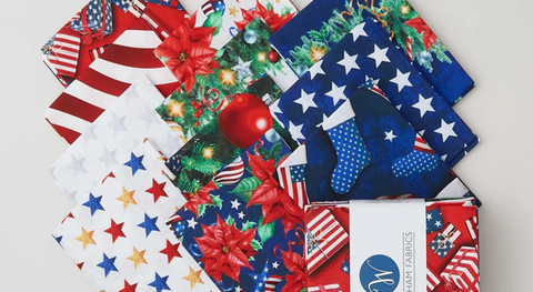 Fat quarter bundle of cotton quilt fabric with a patriotic Christmas theme.