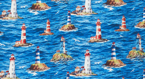 Quilt fabric yardage featuring Lighthouses against a blue ocean with rippling waves from the Beacon of Light fabric collection.