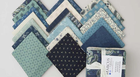 Fat quarter bundle of cotton quilt fabric with blue, green, and tan assorted prints.