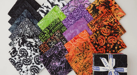 A fat quarter bundle halloween fabric prints featuring moons, stars, and more.