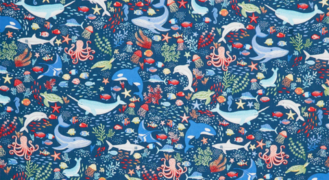 Fabric with colorful sea creatures on a dark blue background, one of several ocean themed prints from the Deep Blue Sea fabric collection.