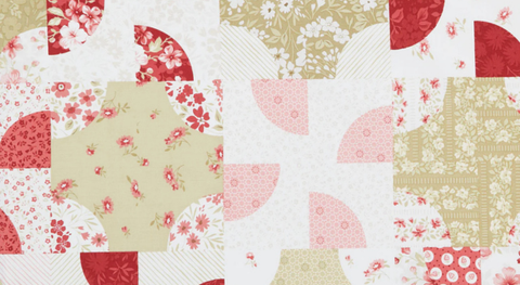 A cheater fabric from the Elizabeth fabric collection featuring red, green, and white floral prints patched together. 