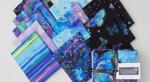 Fat quarter bundle of black, blue, and purple prints inspired by nature and featuring metallic accents.