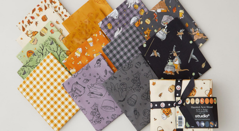 A fat quarter bundle of animals in costumes and other Halloween motifs.