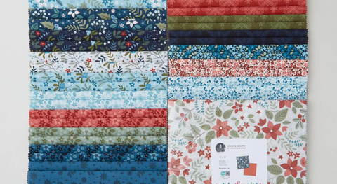 A layer cake of flowers, holly, and more.