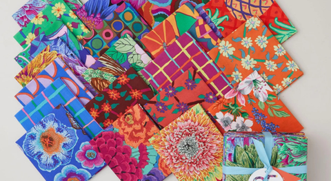 Fat quarter bundle of cotton quilt fabric featuring jewel-tone designs.