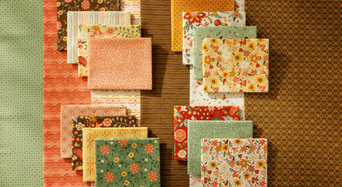 Fat quarter bundle of flowers and mini prints in warm tones.