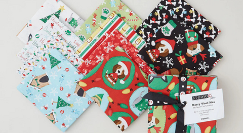 a selection of fat quarter fabrics from the merry woof-mas fabric collection.