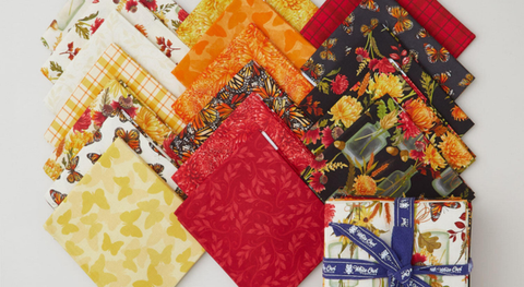 Fat quarter bundle of butterflies, flowers, and plaid in red, orange and yellow from the Monarch Meadow fabric collection.