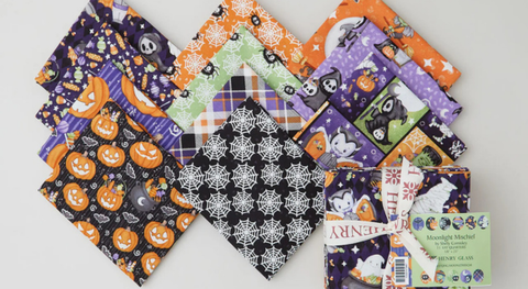 Fat quarter bundle of glow-in-the-dark Halloween motifs in shades of orange, black, purple, and green.