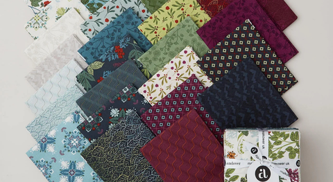 Fat quarter bundle of quilting cotton prints featuring botanical and geometric designs.