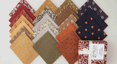 Fat quarter bundle of cotton quilt fabric featuring flowers, foliage and mini prints in autumnal colors. 
