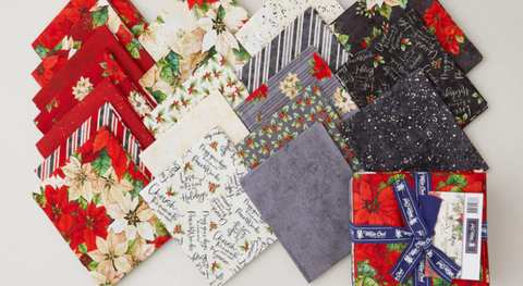 Fat quarter bundle of poinsettias and complementary prints in a red, black, gray, and cream palette.