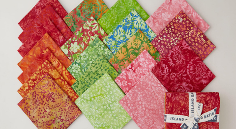 Fat quarter bundle of floral batiks in a pink, lime, red, and orange palette from the Posy Twist Batiks fabric collection.