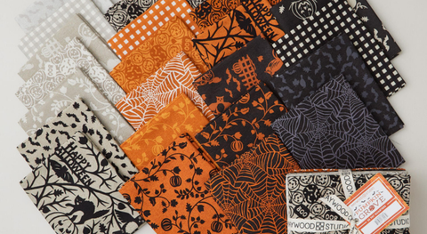 Fat quarter bundle of Halloween motifs in orange, black, and tan.