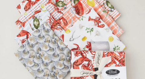 Fat quarter fabrics featuring lobsters, crabs, and clams with a culinary theme.