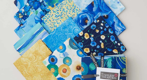 Fat quarter bundle of cotton quilting fabric with poppies and complementary prints in a blue and yellow palette.