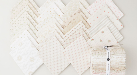 Fat quarter bundle of winter floral fabrics in shades of cream and tan.