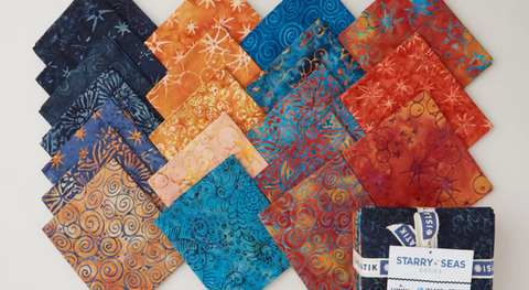 a selection of orange, blue and teal fat quarter fabric prints from the starry seas batiks fabric collection.