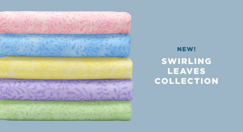 Pick your favorite color of fabric yardage or wide backing from the Swirling Leaves collection.