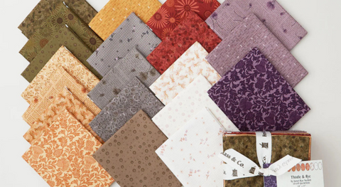 A selection of fat quarter fabrics from the Thistle and Rye collection by Janet Rae Nesbitt.