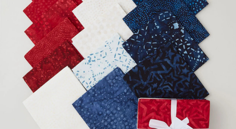 Fat quarters of red, white, blue, and cream batiks from the Patriot's Pride fabric collection by the Combat Quilter.
