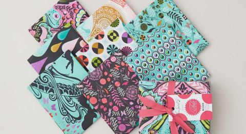 Fat quarter bundle of cotton quilt fabric featuring a frog prince and fun, bright prints.