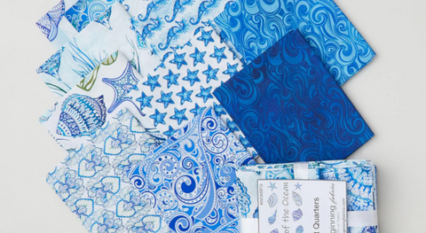 A selection of blue and white fabric prints from the Wonders of the Ocean fabric collection by Jason Yenter.