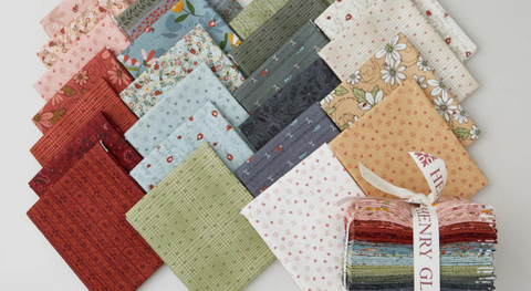 Fat quarter bundle of assorted prints with ladybugs, hearts, and flowers in a sweet yet subtle color palette.